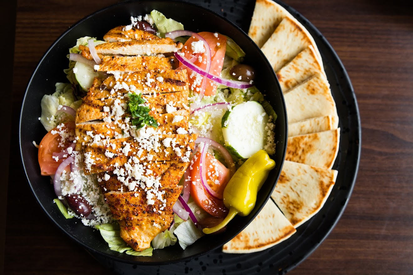 Grilled sliced meat, salad with cheese, snacks on the side